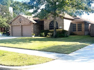 All brick custom beauty, complete sprinkler system, lush landscaping , solar screens, seller has paid attention to the finest detail | Image 2