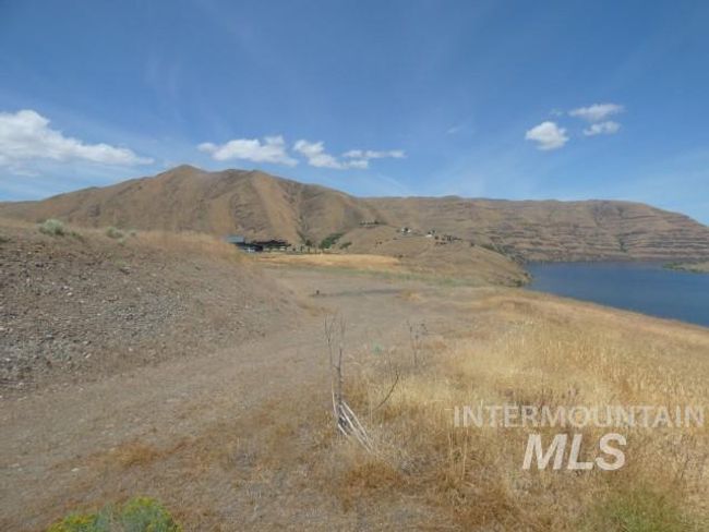 View of mountain backdrop with a large body of water | Image 12
