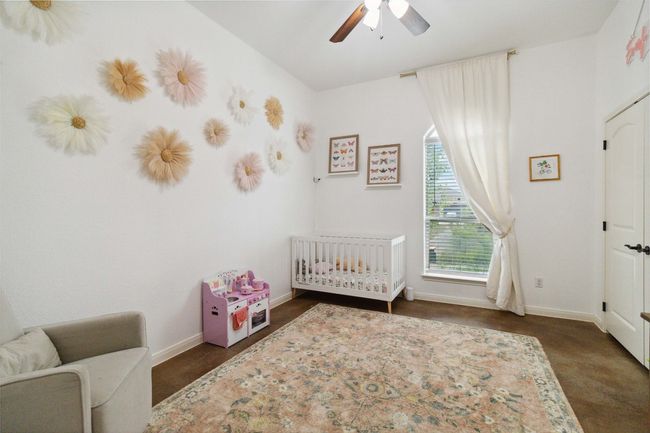 Bedroom with a crib, baseboards, and ceiling fan | Image 18