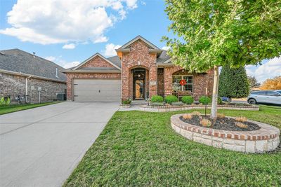 View of front of house with a front yard, central AC, and a garage | Image 1