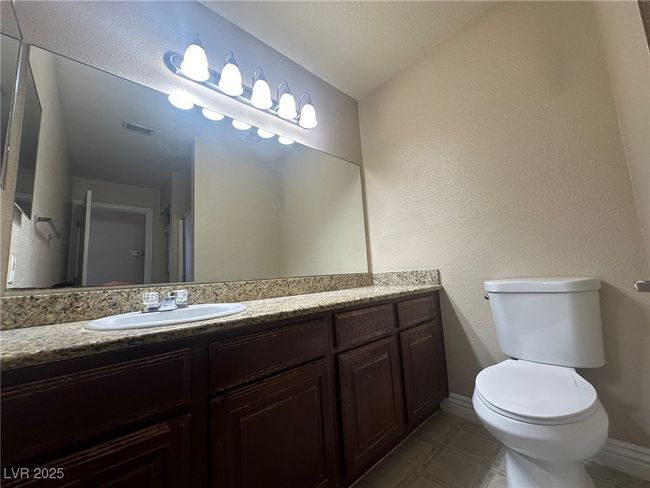 Bathroom featuring toilet, vanity, and baseboards | Image 11