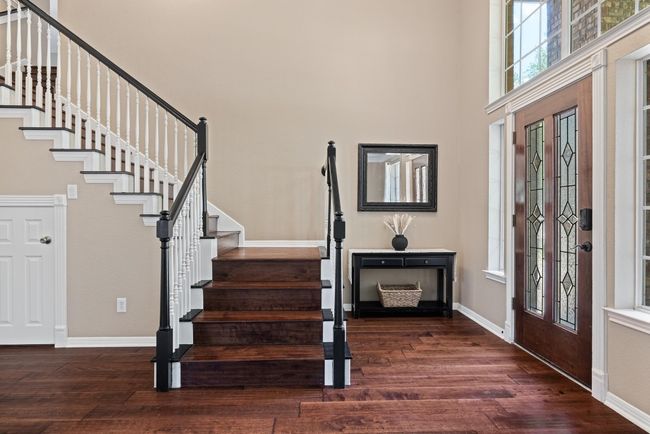 The entry makes an immediate impression, with natural light pouring in, high ceilings overhead, and a graceful staircase that draws your eye upward the moment you walk through the door | Image 4