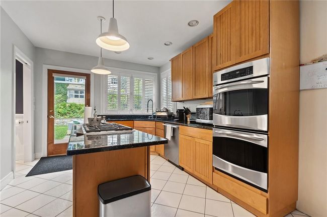 The recently updated kitchen along with Wolf range, double oven and stainless steel appliances | Image 10