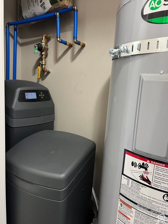 Detailed view of electric water heater and a water softener system | Image 59