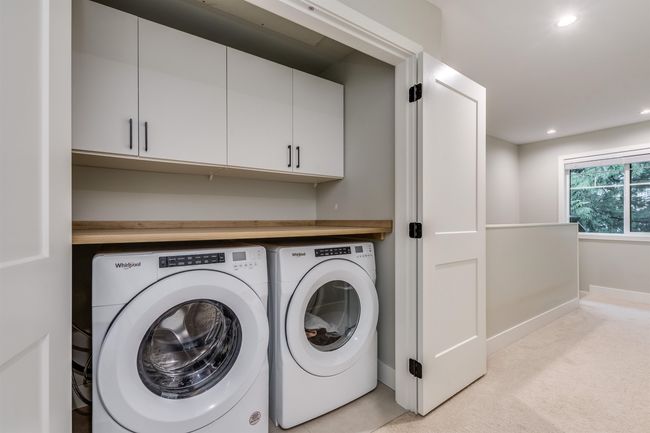 Clothes washing area with recessed lighting, light colored carpet, cabinet space, baseboards, and washer and clothes dryer | Image 10