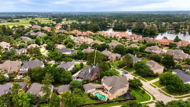 An aerial view of the home surrounded by other beautiful homes, within a short walk to the lake. Enjoy bike and walking trails in your new neighborhood. | Image 40