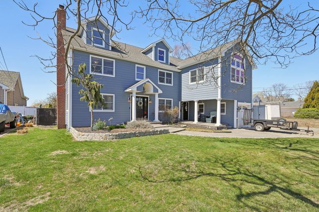 View of front of property featuring a front yard, fence, and a chimney | Image 4