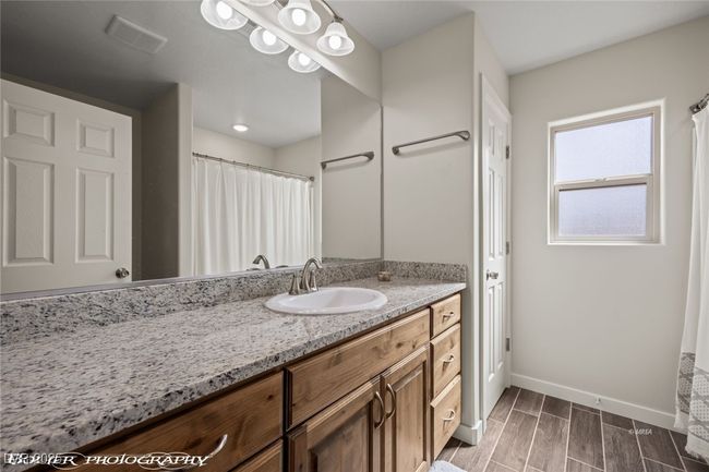 Bathroom featuring baseboards, vanity, and wood finish floors | Image 13