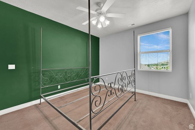 Carpeted bedroom featuring baseboards, visible vents, and a ceiling fan | Image 35