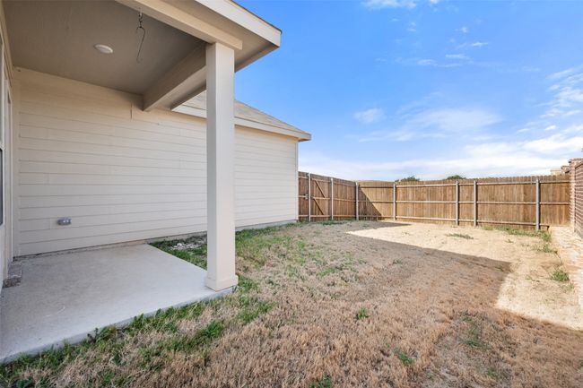 View of yard featuring a patio and a fenced backyard | Image 13
