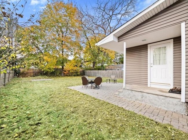 View of yard featuring a patio, a fire pit, and a fenced backyard | Image 10