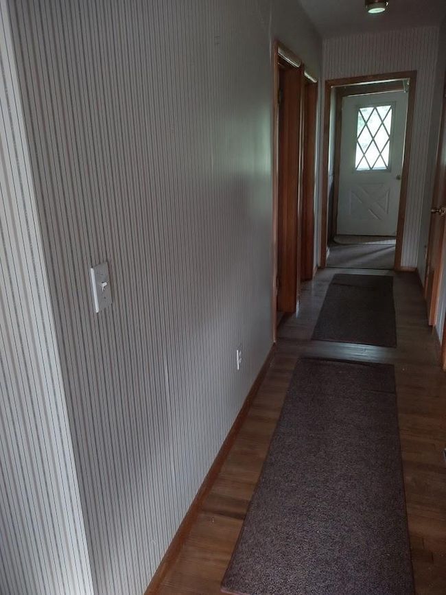 Hallway with dark wood-type flooring | Image 17