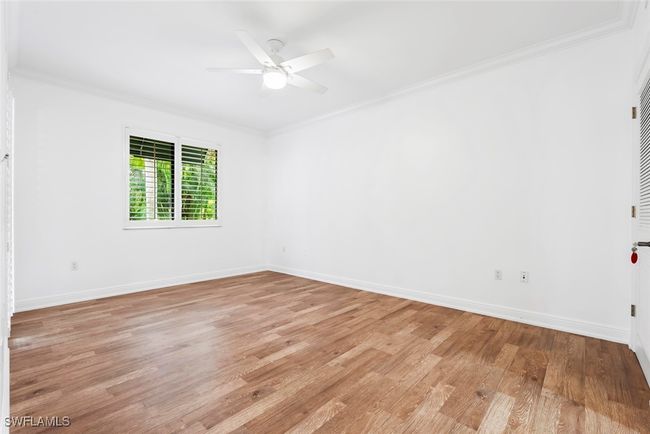 Spare room featuring ceiling fan, ornamental molding, and light hardwood / wood-style flooring | Image 38