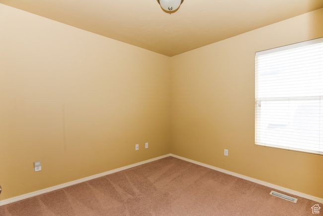 Empty room with baseboards, carpet flooring, and visible vents | Image 25