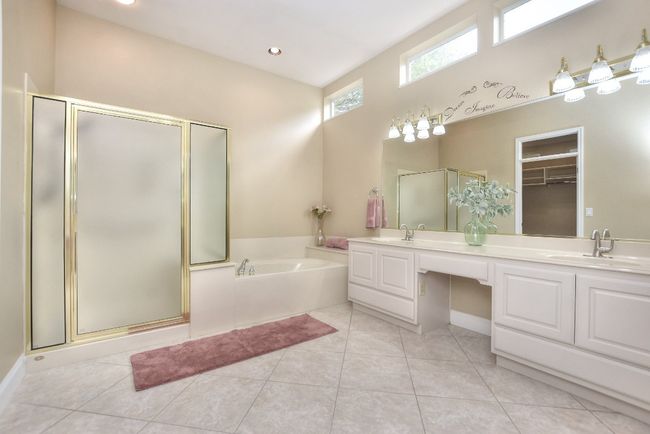 Large double vanity with seating, standing shower and soaker tub. | Image 19
