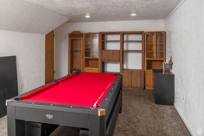Rec room with dark carpet, a textured ceiling, billiards, and lofted ceiling | Image 25