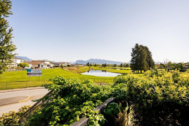 Surrounding community featuring fence, a water and mountain view, a lawn, and view of golf course | Image 23