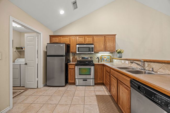 Kitchen next to the laundry room and pantry leads to the garage. | Image 9