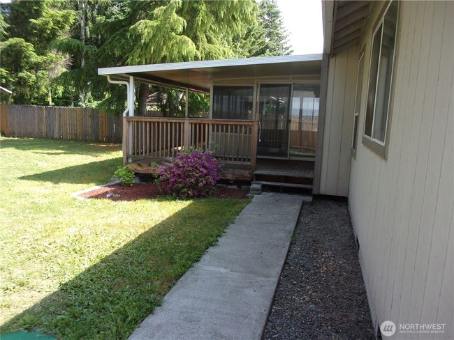 Sidewalk leads up the deck and into the sun room. | Image 6