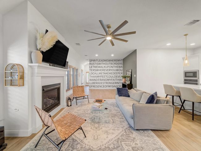 Living area with light wood-style flooring, a fireplace, recessed lighting, and a ceiling fan | Image 14