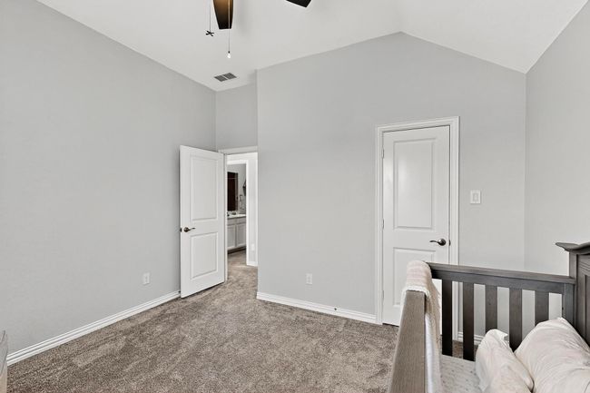 Bedroom featuring carpet floors, vaulted ceiling, and a ceiling fan | Image 25