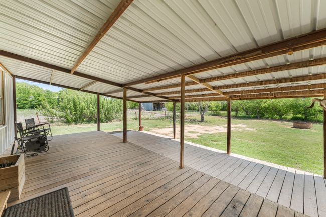 Wooden terrace featuring a lawn | Image 19