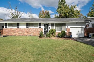 Ranch-style home with a garage and a front lawn | Image 1