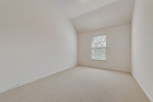 Spare room with light carpet and lofted ceiling | Image 16