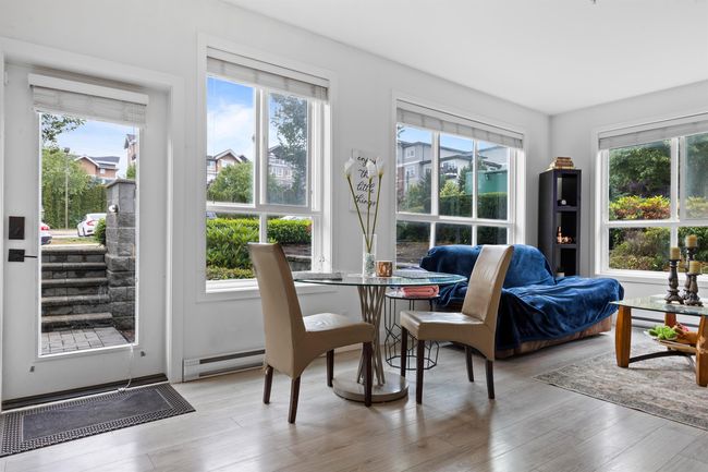 Dining area with wood finished floors and a baseboard radiator | Image 33