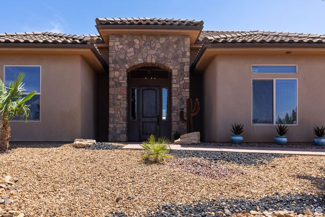 Property entrance with a tile roof, stucco siding, and stone siding | Image 48