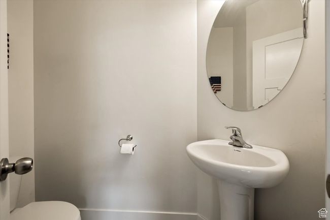 Half bath with a sink and toilet | Image 26