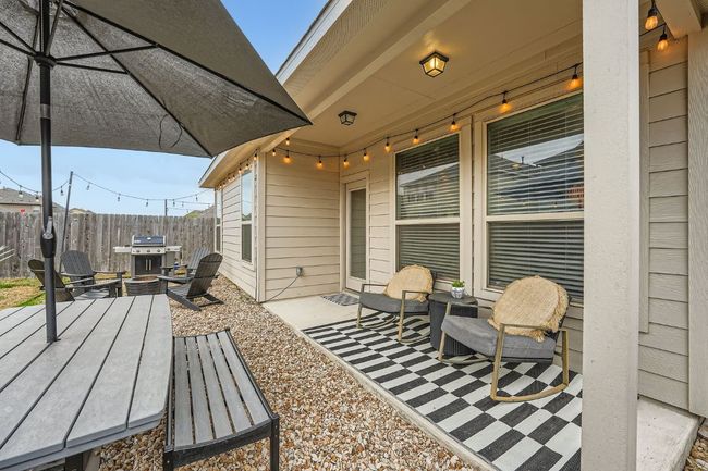 View of patio / terrace with an outdoor fire pit, fence, and area for grilling | Image 24