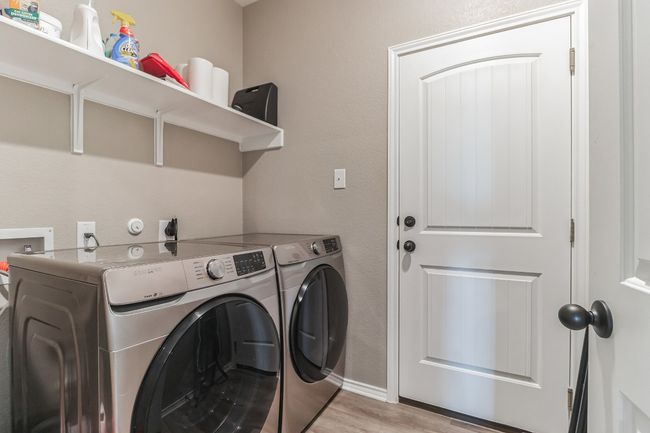 Laundry area with washer and dryer and light wood-style flooring | Image 16