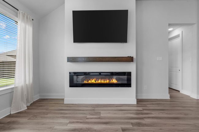 Detailed view of wood finished floors and a glass covered fireplace | Image 9