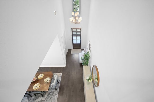 Foyer entrance with an inviting chandelier with a high ceiling. | Image 6
