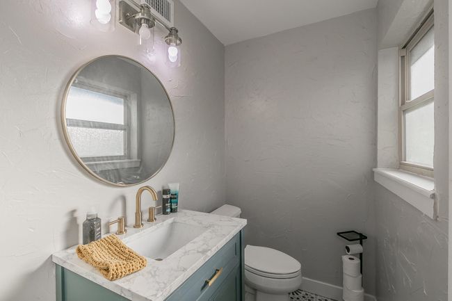 Bathroom featuring vanity and toilet | Image 12