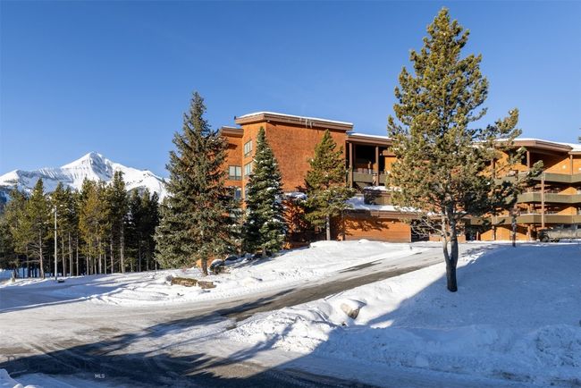 Snow covered building with a mountain view | Image 32