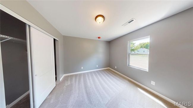 Unfurnished bedroom featuring light carpet, baseboards, and a closet | Image 20