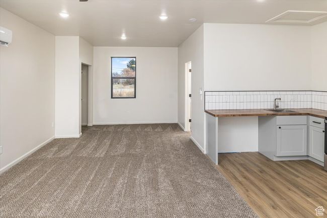 Interior space with an AC wall unit and sink | Image 38