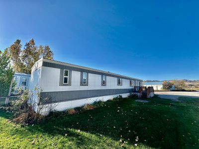 View of property exterior with a yard | Image 1