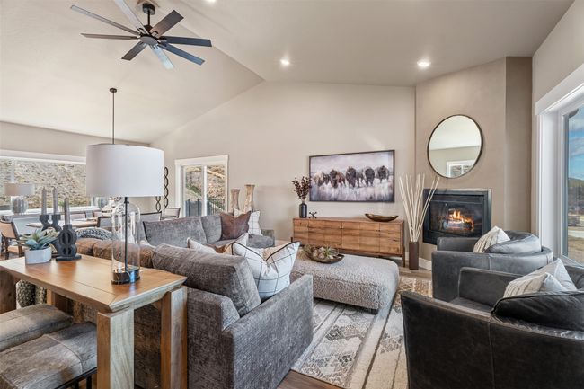 Living area with wood finished floors, plenty of natural light, a ceiling fan, vaulted ceiling, and recessed lighting | Image 39
