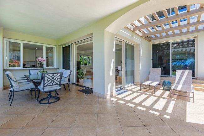 The wrap-around lanai offers a covered area with convenient access to the kitchen & great room | Image 29
