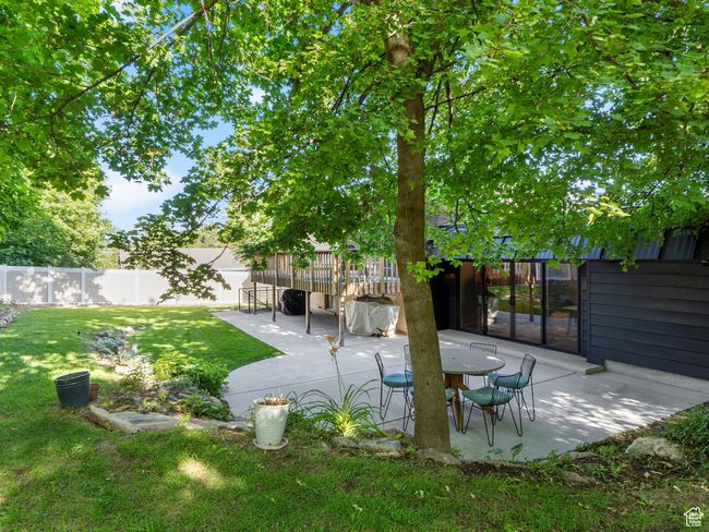 Fenced backyard with a patio area | Image 42
