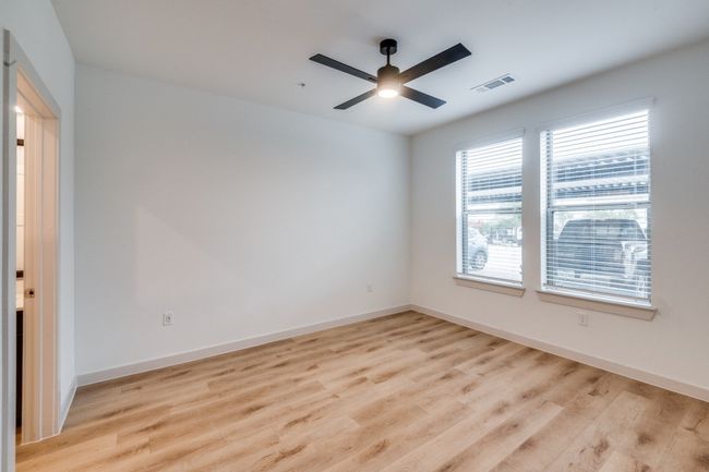 Empty room featuring visible vents, light wood-style flooring, and baseboards | Image 8