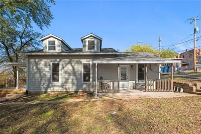 View of front of home featuring a front lawn and covered porch | Image 1