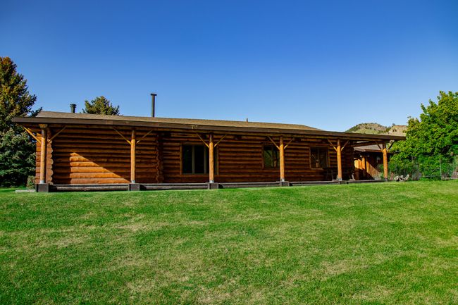 Rear view of house featuring log exterior and a shingled roof | Image 55