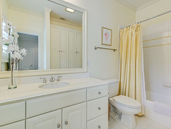 Bathroom with toilet, vanity, crown molding, shower / bath combo, and tile patterned floors | Image 16
