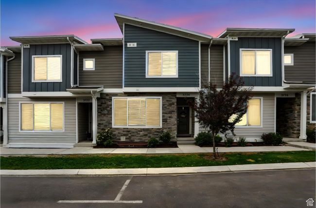 Dusk View of property featuring board and batten siding, stone siding, and uncovered parking | Image 45