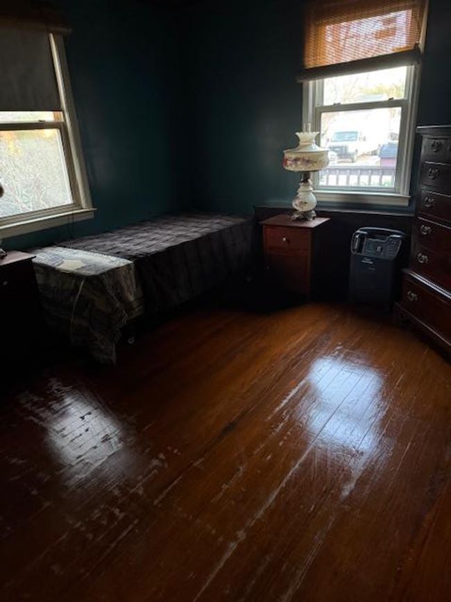 Bedroom with multiple windows and dark wood-type flooring | Image 18