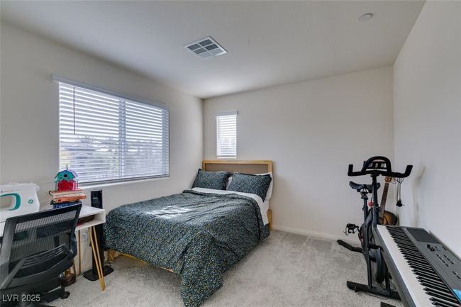 Carpeted bedroom featuring visible vents and baseboards | Image 21